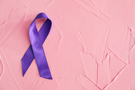 Purple ribbon on color background. Pancreatic cancer awareness conceptの写真素材