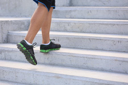 Sporty young man running outdoorsの写真素材