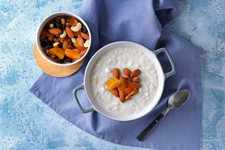 Delicious rice pudding with dried apricots and almonds in casserole on tableの写真素材