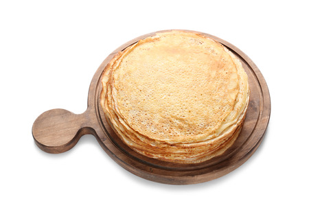 Board with tasty thin pancakes on white backgroundの写真素材