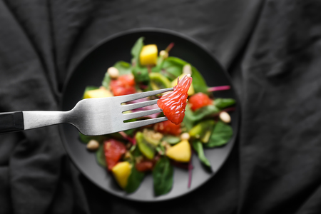 Eating of healthy fresh salad, closeupの写真素材