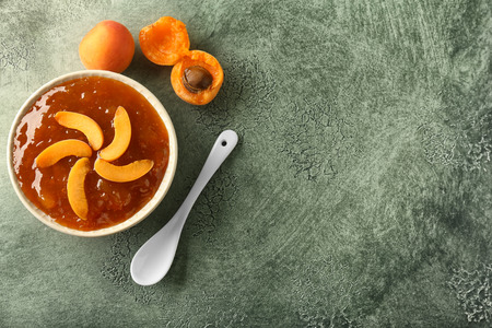 Plate with sweet apricot jam on color tableの写真素材