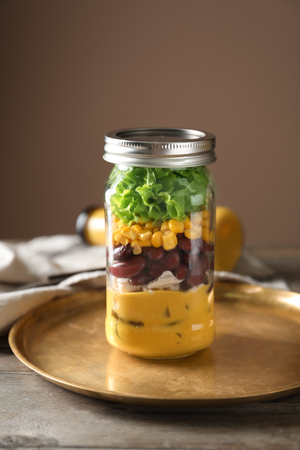 Delicious vegetable salad in mason jar on metal trayの写真素材