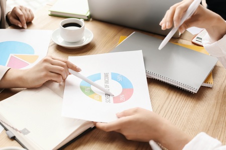 Women with diagram during business meeting in officeの写真素材