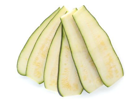 Fresh sliced zucchini isolated on whiteの写真素材