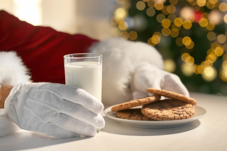 Santa Claus eating cookies and drinking milk at table, closeupの写真素材