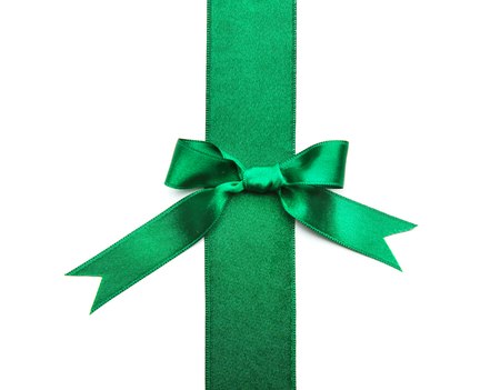Green ribbon with bow on white backgroundの写真素材