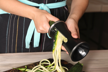 Woman making zucchini spaghetti, closeupの写真素材