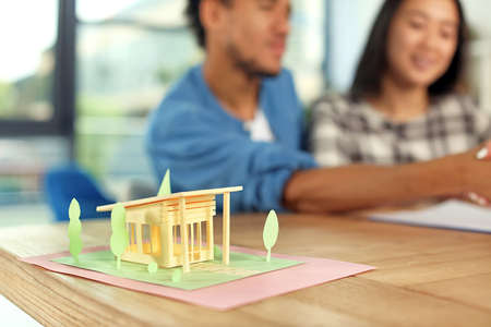 Model of house on table in office of real estate agentの写真素材