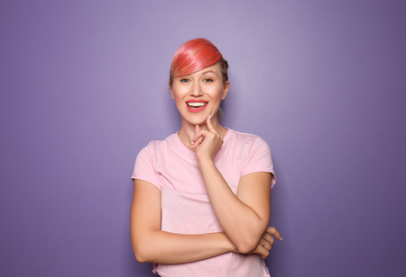 Beautiful young woman with unusual hair on color backgroundの写真素材