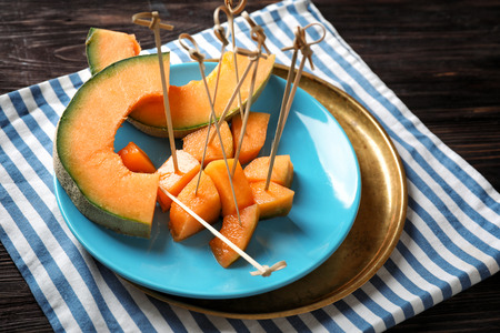 Plate with tasty cut melon on tableの写真素材