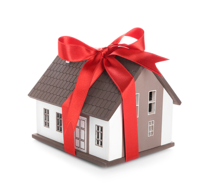 House model with red ribbon on white background. Mortgage conceptの写真素材