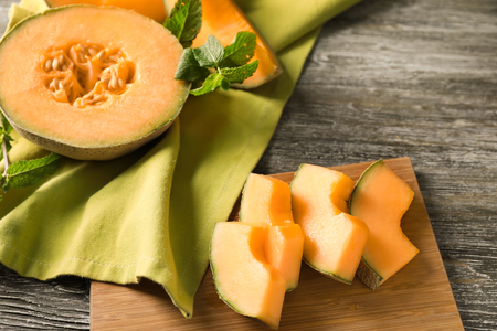 Cut ripe melons on wooden tableの写真素材