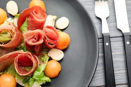 Delicious melon balls with prosciutto and mozzarella cheese on plate, closeupの写真素材