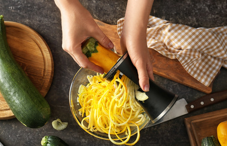 Woman making zucchini spaghetti, closeupの写真素材