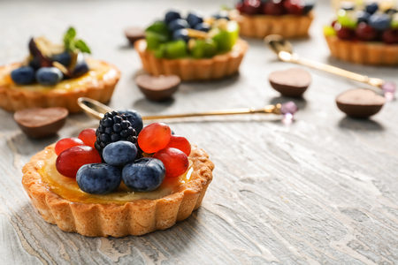 Delicious tart with berries on wooden tableの写真素材