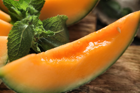 Slice of ripe melon on table, closeupの写真素材