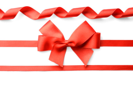Red ribbons with beautiful bow on white backgroundの写真素材
