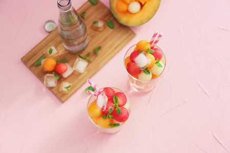 Composition with tasty melon balls on color tableの写真素材