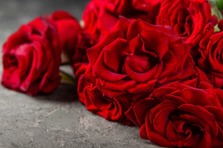 Beautiful bouquet of red roses on grey table, closeupの写真素材