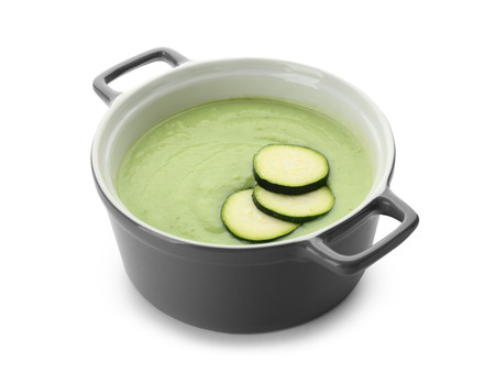 Tasty zucchini soup in saucepan on white backgroundの写真素材