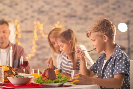Happy family having Christmas dinner at homeの写真素材