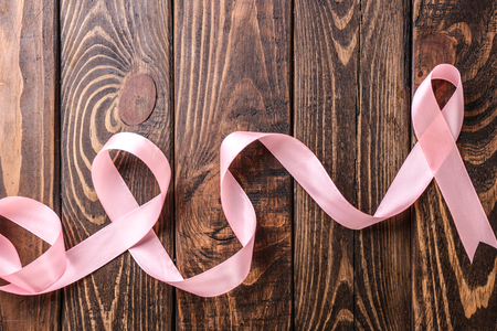 Pink ribbon on wooden background. Breast cancer conceptの写真素材