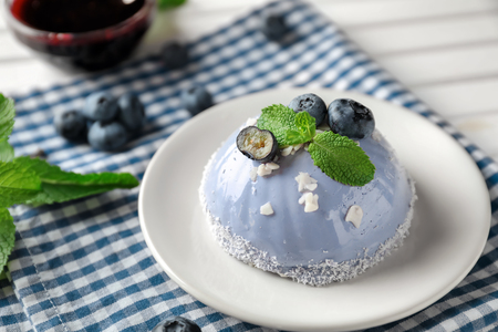 Plate with delicious blueberry dessert on tableの写真素材