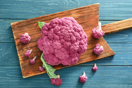 Purple cauliflower on wooden boardの写真素材