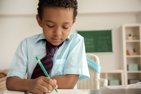 African-American boy doing exercise in classroom