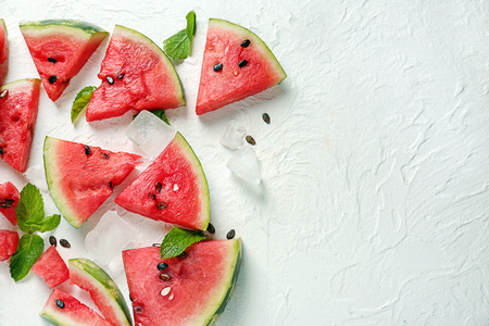 Slices of watermelon and ice cubes on white backgroundの写真素材