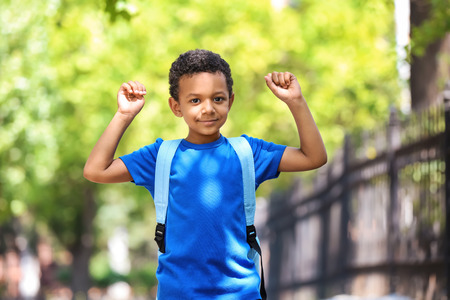 Cute African-American schoolboy outdoorsの写真素材