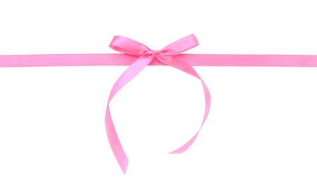 Pink ribbon with bow on white backgroundの写真素材