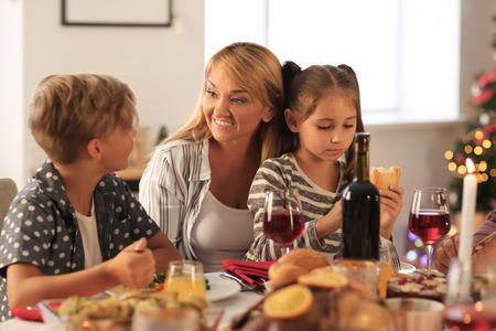 Happy family having Christmas dinner at homeの写真素材
