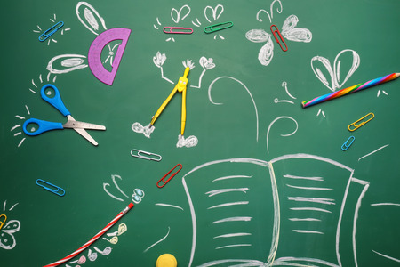Creative composition with school stationery on chalkboardの写真素材