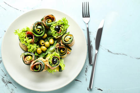 Tasty zucchini rolls with prosciutto on plateの写真素材