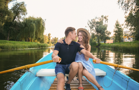 Cute young couple having romantic date in boatの写真素材