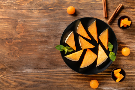 Composition with delicious melon slices on wooden tableの写真素材