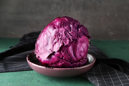 Bowl with ripe red cabbage on green tableの写真素材