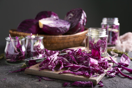 Board with cut red cabbage on grunge tableの写真素材