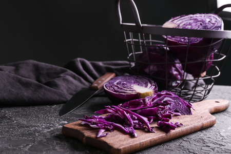 Board with cut red cabbage on grunge tableの写真素材