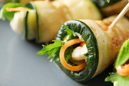 Tasty zucchini rolls on plate, closeupの写真素材