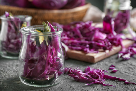 Glass jar with cut red cabbage on grunge tableの写真素材