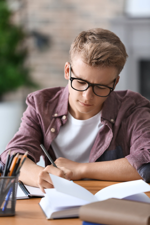 Teenager boy doing homework at homeの写真素材