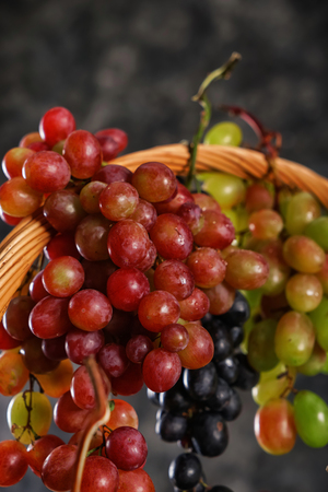 Wicker basket with fresh ripe grapes, closeupの写真素材