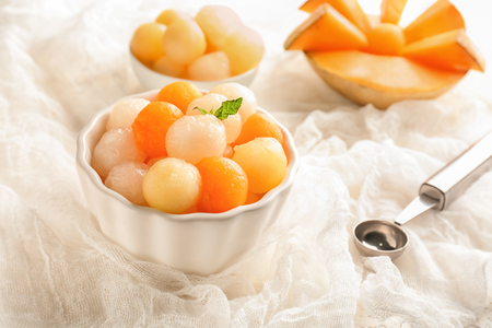 Bowl with delicious melon balls on tableの写真素材