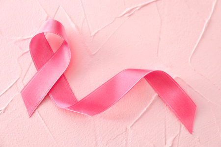 Pink ribbon on color background. Breast cancer conceptの写真素材
