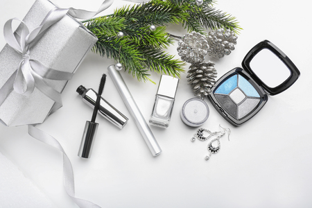 Set of cosmetics with Christmas present and decorations on white backgroundの写真素材