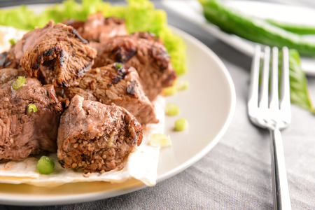 Plate with delicious shish kebab on table, closeupの写真素材