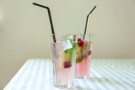 Glasses of fresh raspberry mojito on tableの写真素材